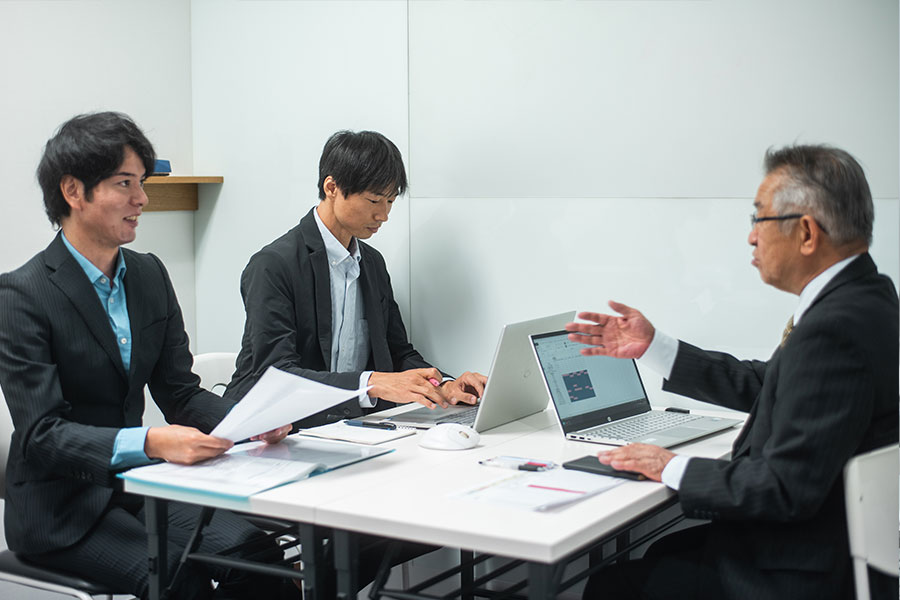 Two male interpreters meeting with a client